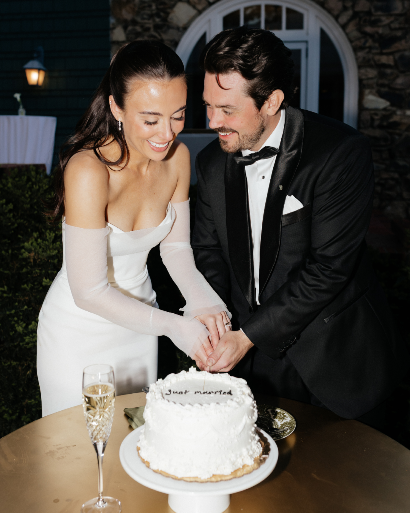 Bride and groom cut their wedding cake together during their reception at The VanLandingham Estate in Charlotte.