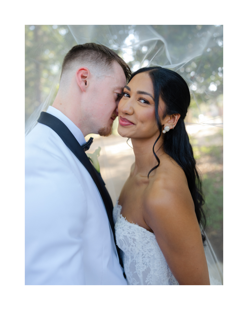 Bride and groom share an intimate portrait beneath the bridal veil during their wedding at The VanLandingham Estate in Charlotte, captured by Shelby Beckler Photography.