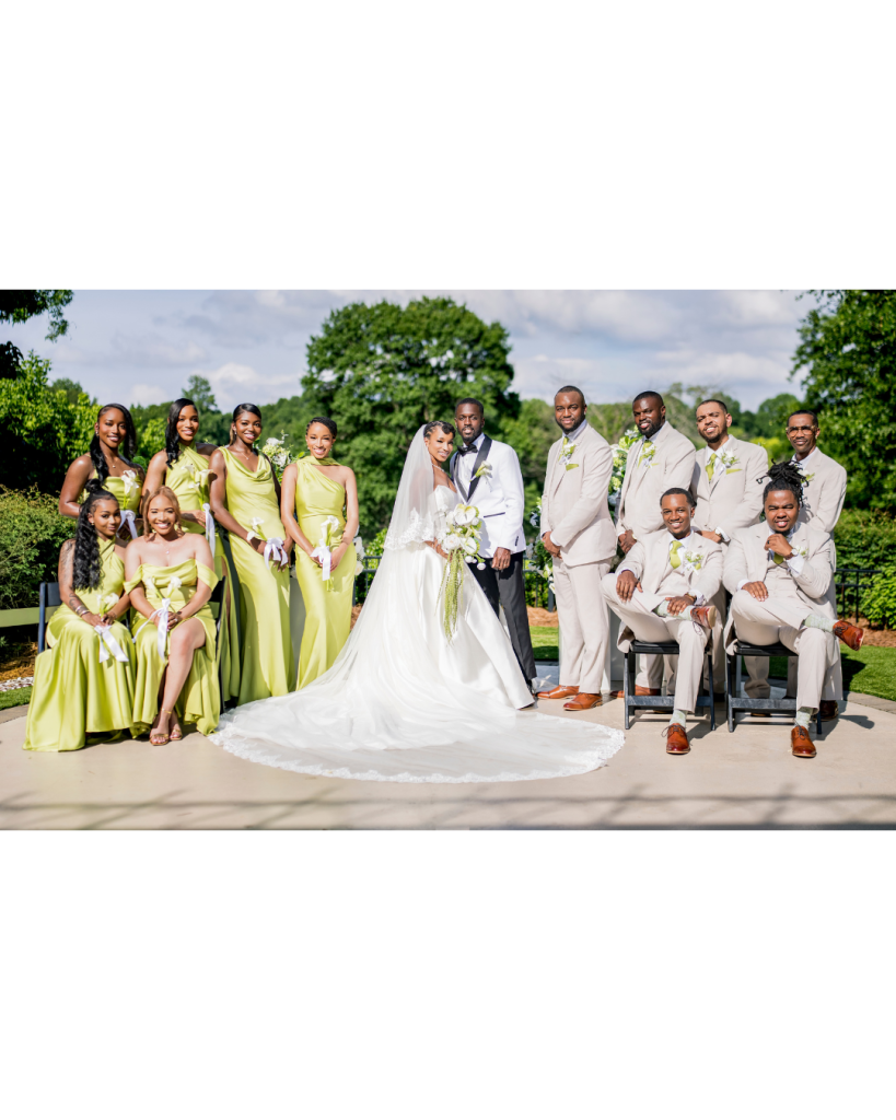 Bride and groom pose with their wedding party outdoors at Riverwalk Event Venue with chartreuse bridesmaid dresses and neutral groomsmen suits.