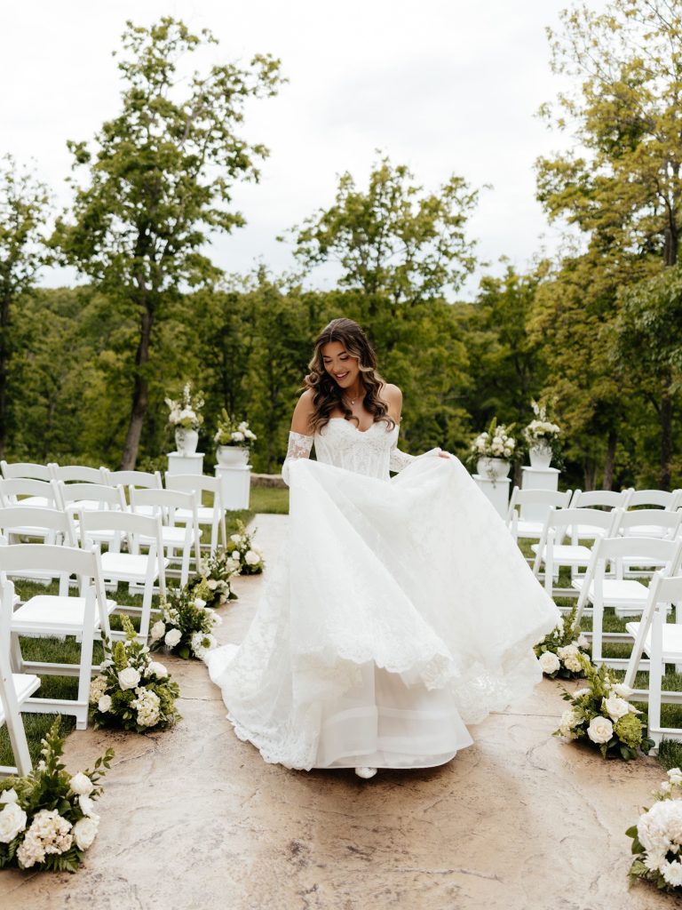 Bride posing on patio at French-inspired wedding venue, Silver Oaks Chateau.