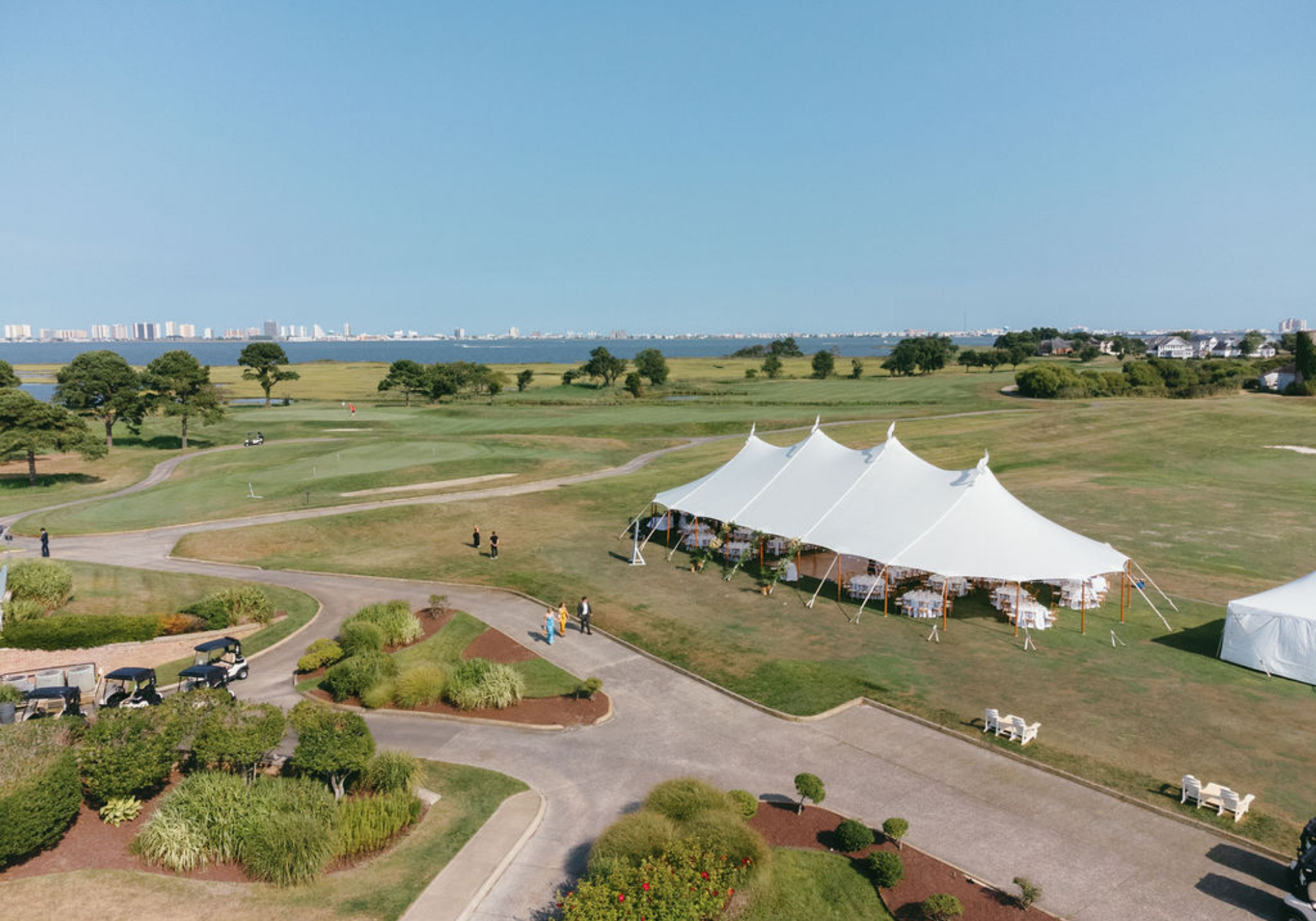 Aerial view of the sailcloth tent wedding reception overlooking marshland and the bay near Ocean City, Maryland.