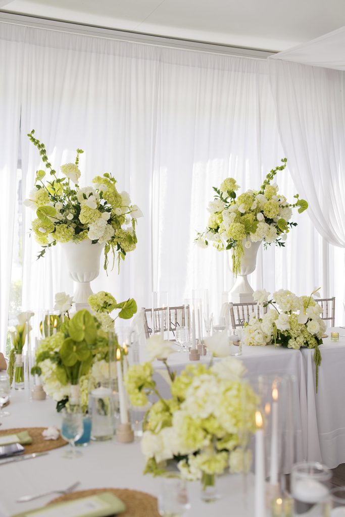 Large white and green wedding florals at reception at Knotting Hills Wedding Venue & Resort.
