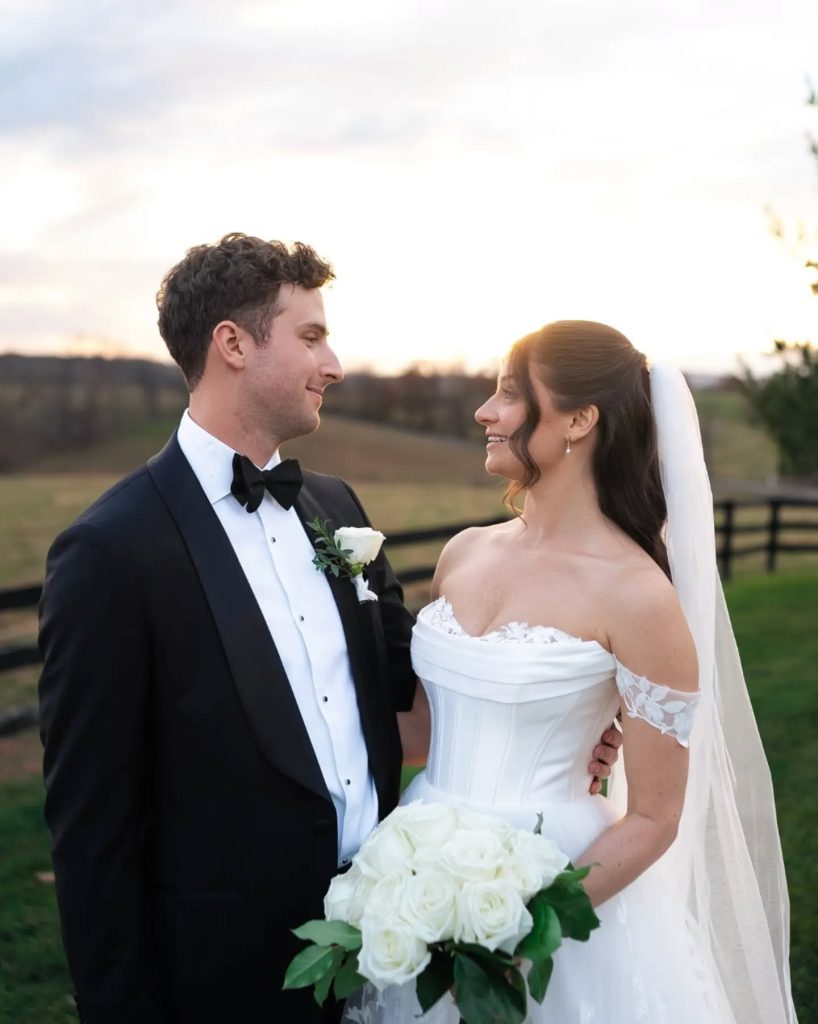 bride and groom looking at each other at outdoor wedding venue during couples portraits in northern virginia