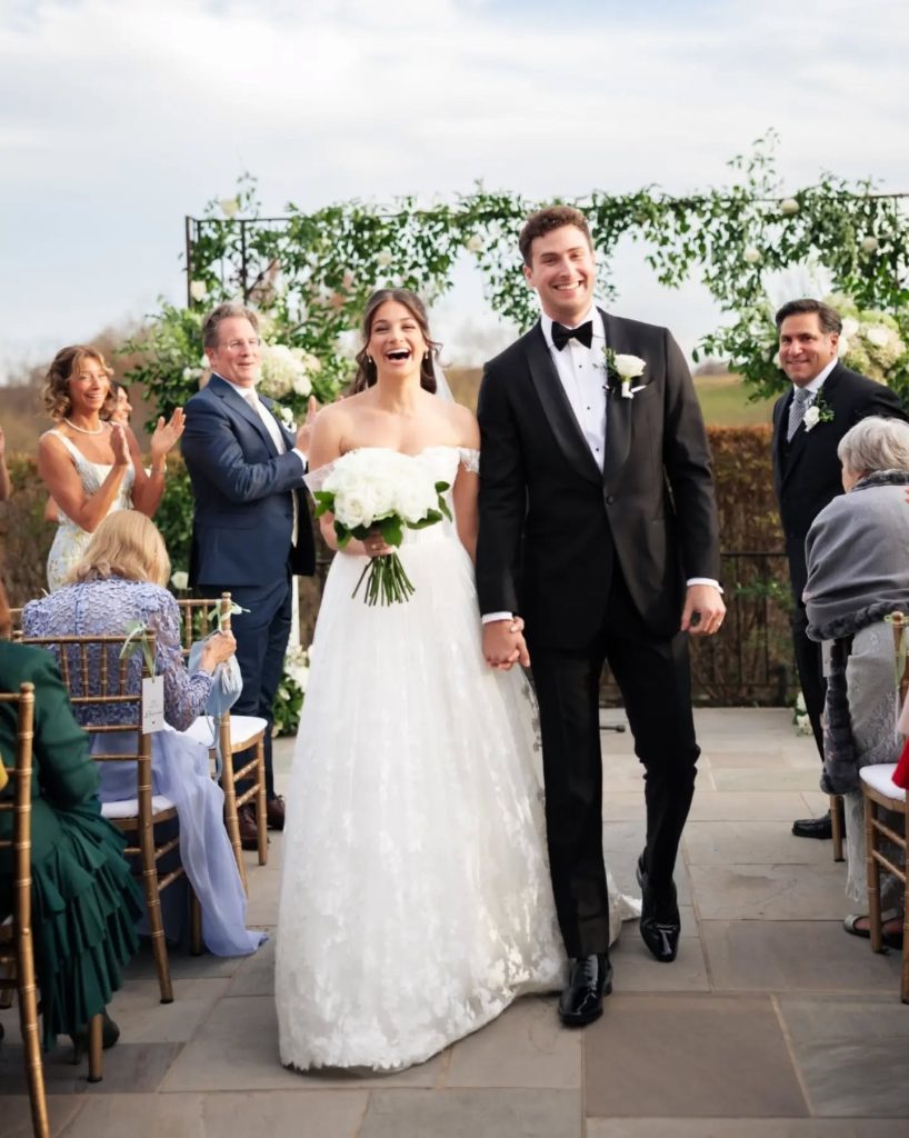 bride and groom smiling walking back down aisle after getting married at outdoor wedding venue in luxury northern virginia wedding venue
