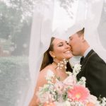 groom kissing bride underneath wedding veil light and airy wedding style northern virginia