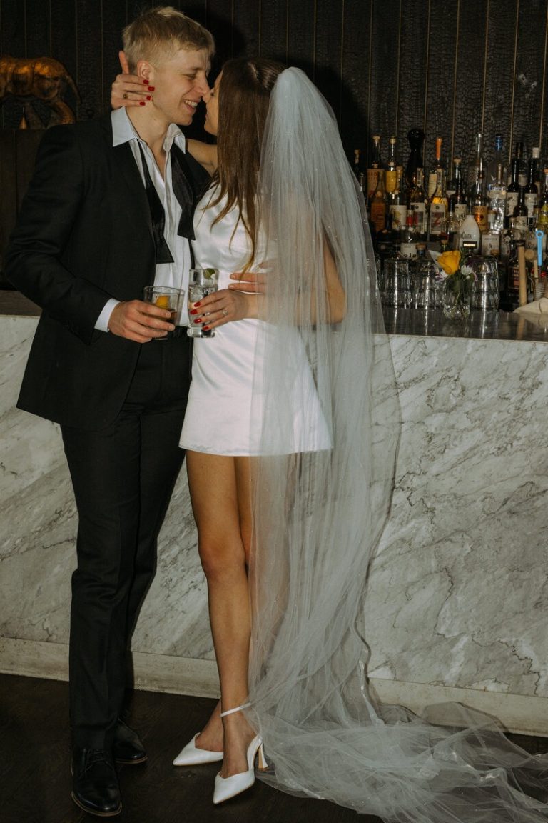 bride and groom kissing at wedding reception bar in northern virginia