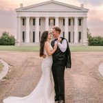 bride and groom couple posing in front of wedding reception venue in NOVA DMV
