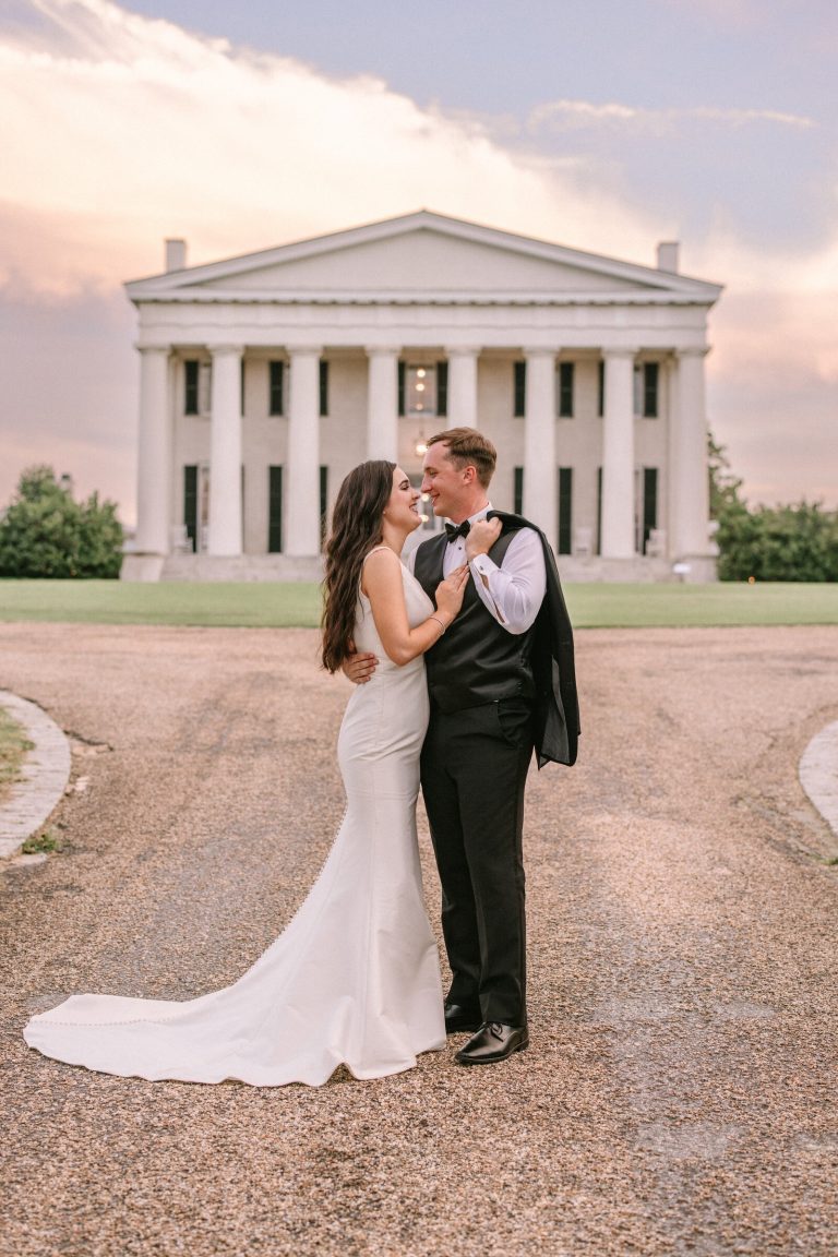 bride and groom couple posing in front of wedding reception venue in NOVA DMV