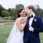 Bride leaning into her groom with bridal makeup and hair done by LUX Studio.