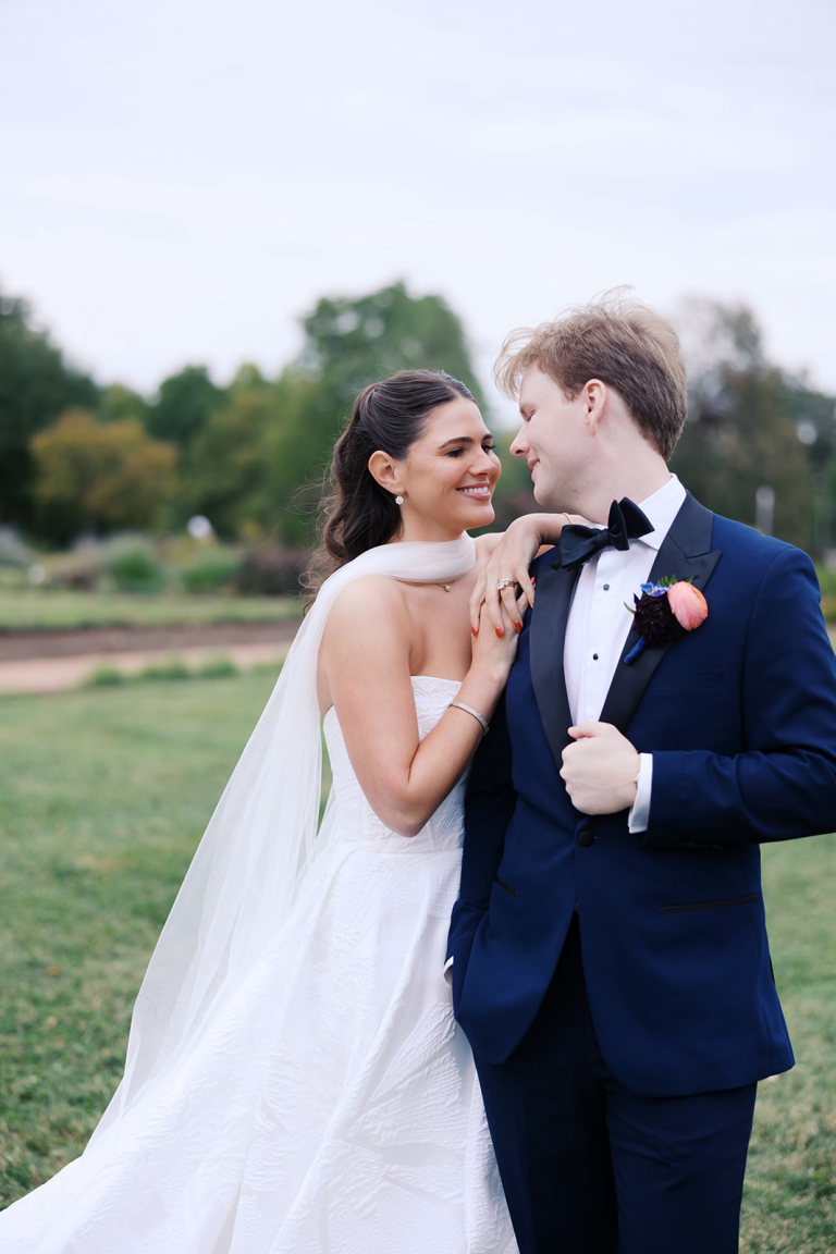 Bride leaning into her groom with bridal makeup and hair done by LUX Studio.