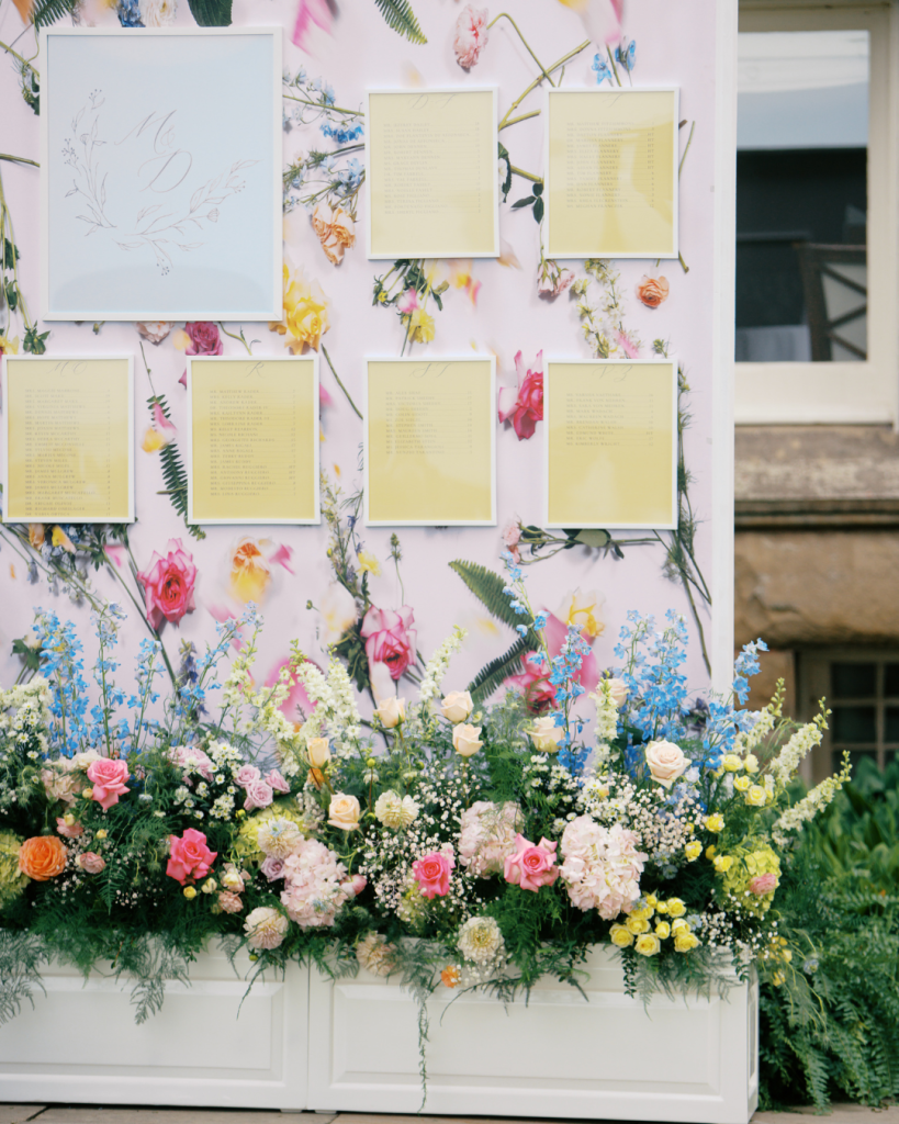 Bright colored seating chart with floral arrangement