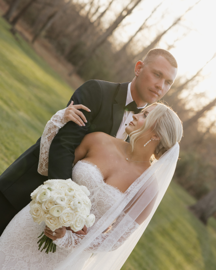 Bride and groom embracing outdoors during sunset portraits at The Providence Cotton Mill wedding venue in Maiden, North Carolina.