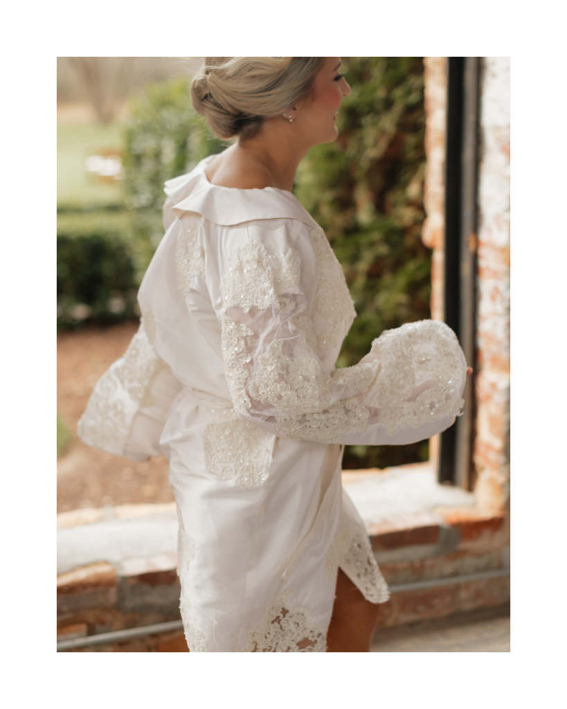 Bride walking in a detailed white getting ready robe inside the historic venue before the ceremony.