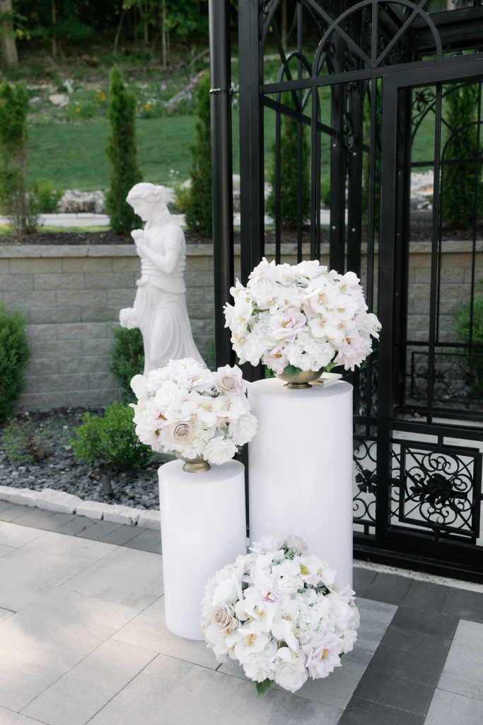 Elegant, white floral arrangement at an outdoor wedding ceremony at Knotting Hills Wedding Venue & Resort.