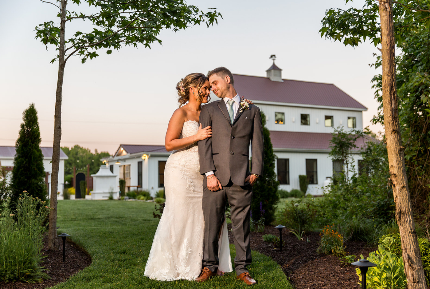 Bride and groom embracing outside a modern barn wedding venue during a Boutique Bride wedding planned in Delaware and Maryland's Eastern Shore.