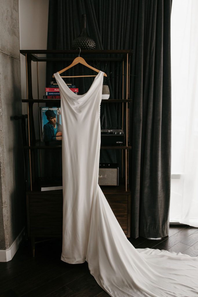 White satin wedding dress hanging
