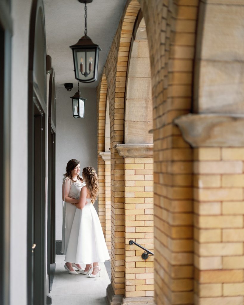 Two brides standing outside of The Elliot venue in Cleveland