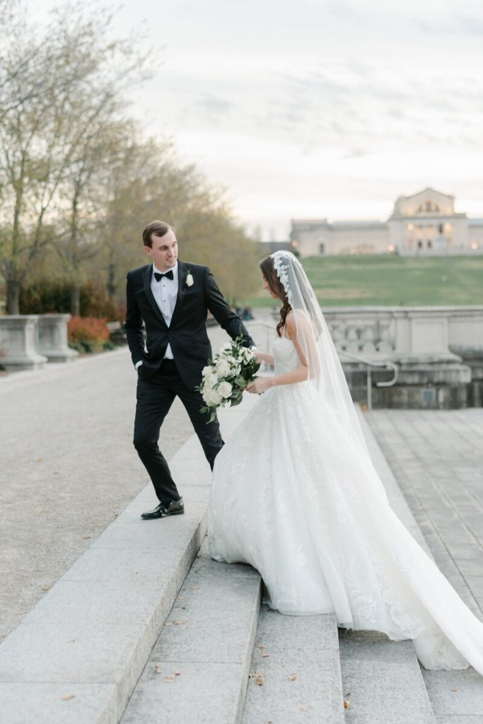Bride and groom walking near The St. Louis Art Museum captured by Alex Nardulli.
