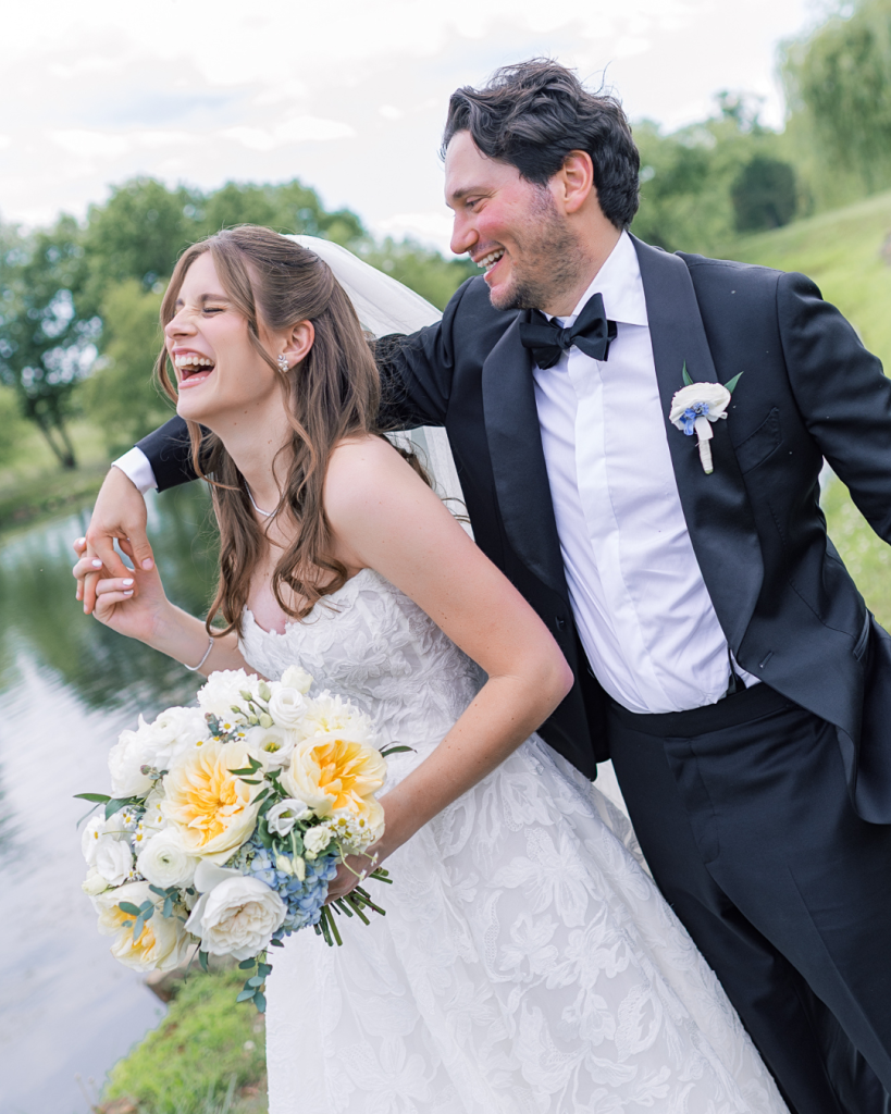 bride and groom laughing together during wedding portrait session at outdoor vineyard in northern virginia loudoun county