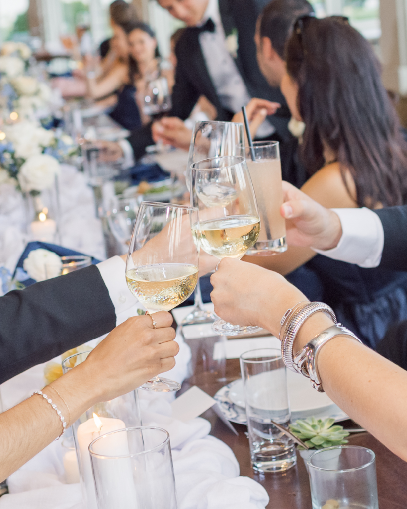 wedding tablescape with guests cheersing their glasses of champagne winery vineyard