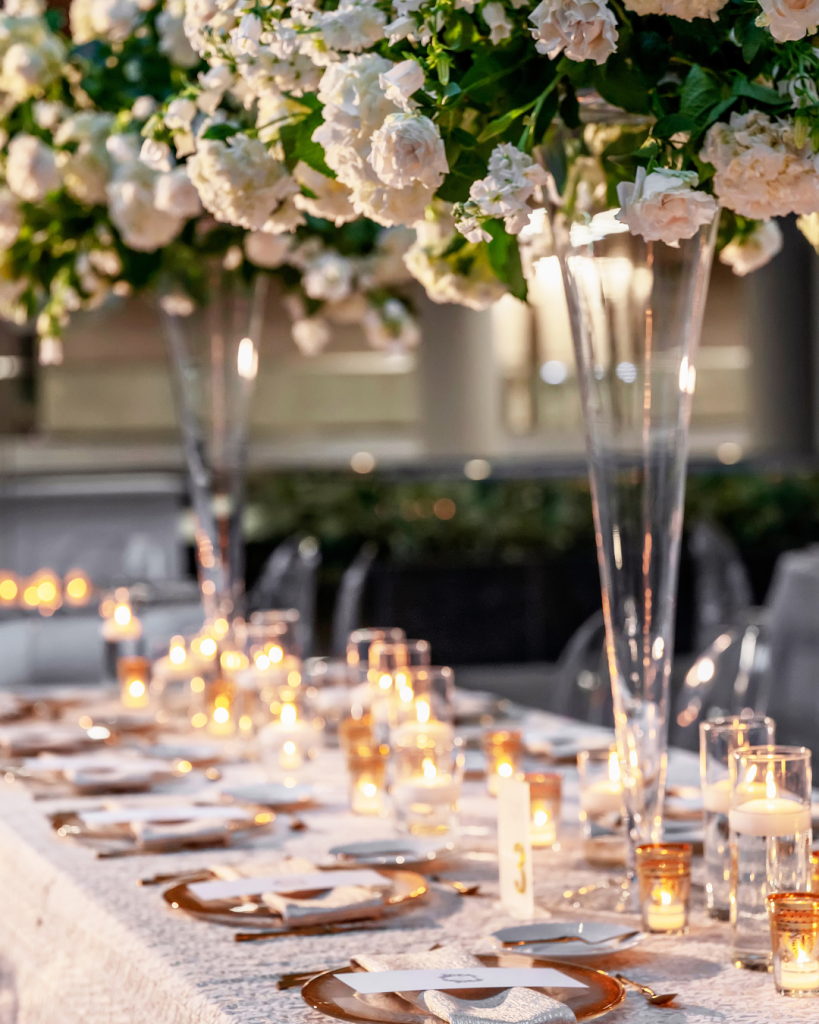 Wedding detail collage featuring white florals, crystal champagne glasses, Joy’s bridal portrait and a sculptural white wedding cake.