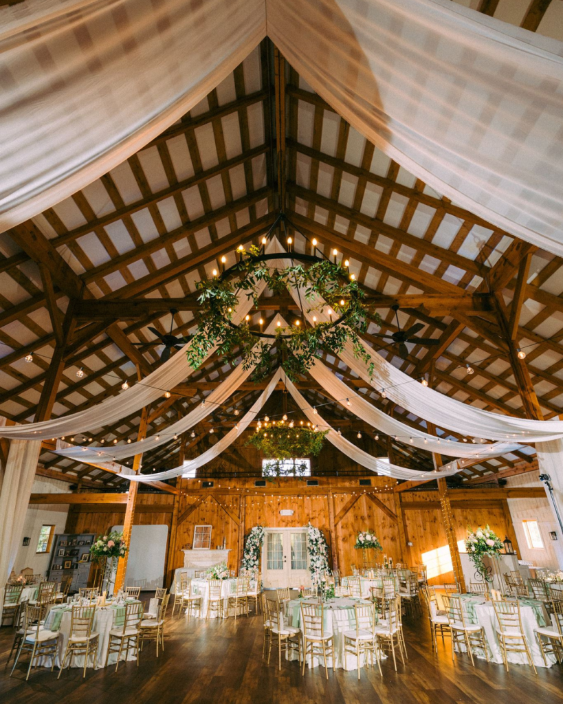 reception view of drapery on ceilings and green and white tablescapes