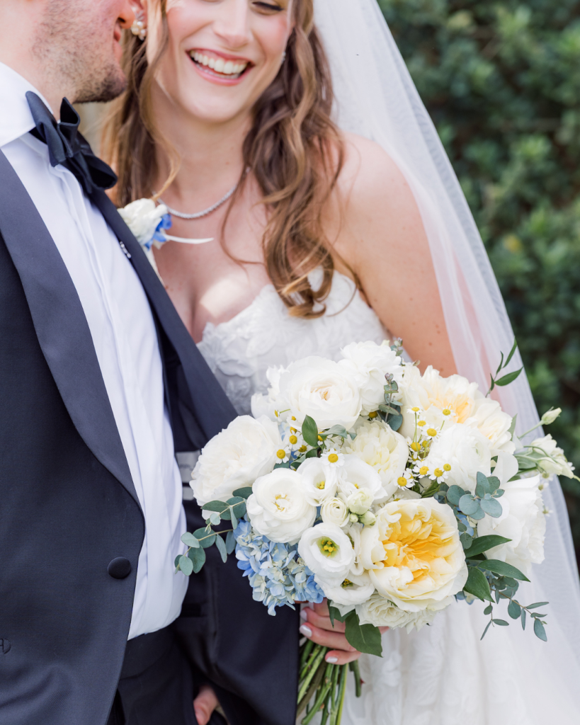 bride getting kiss on cheek from groom during portrait session at loudoun vineyard