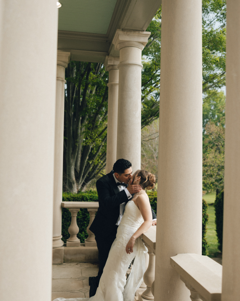 bride and groom on patio of estate manor in northern virginia