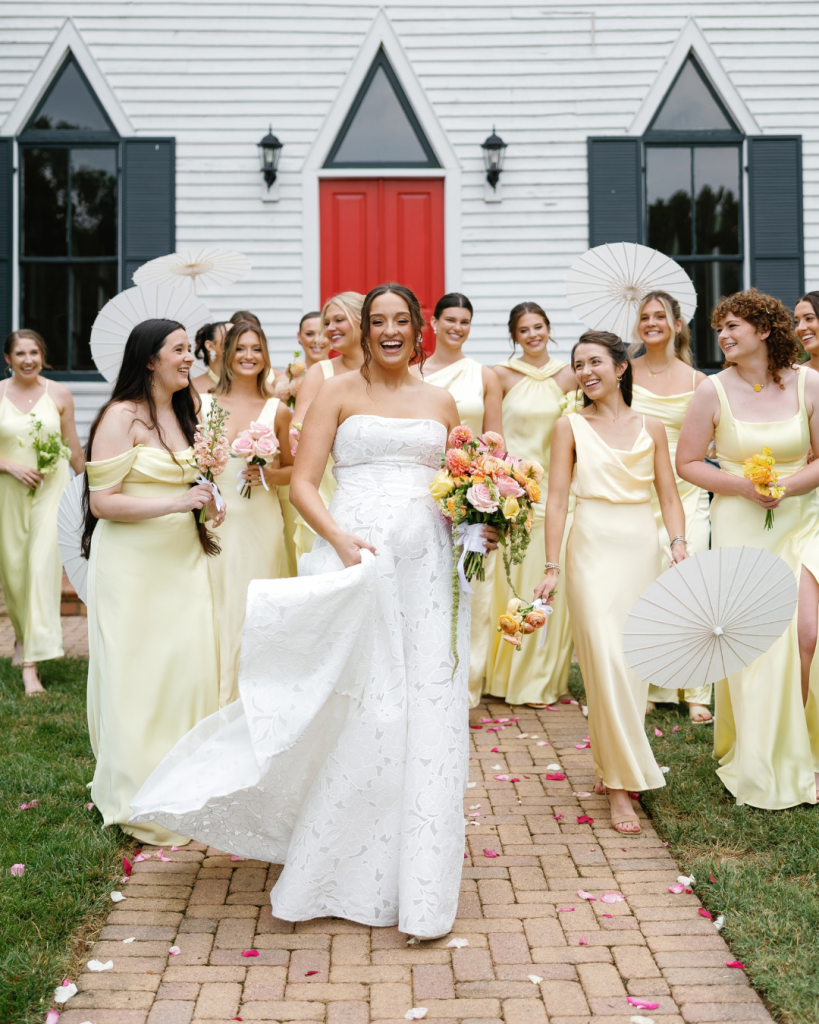 Lauren walks with her bridesmaids in soft yellow dresses outside the Chapel at Morning Star following the wedding ceremony.