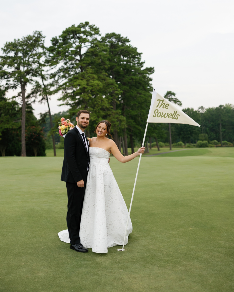 Lauren and Peyton pose on the golf course at Pine Lake Country Club with a personalized flag reading “The Sowells.”