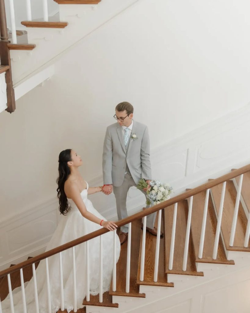 bride and groom walking upstairs at estate manor wedding venue in virginia