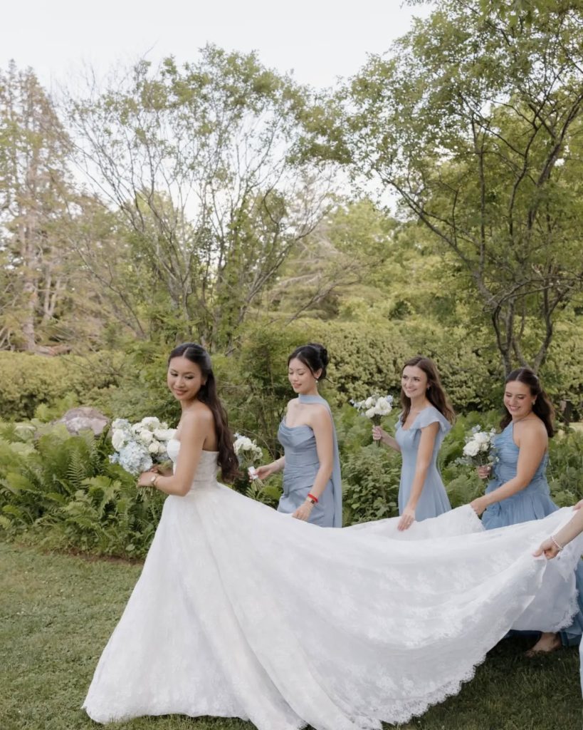 bride with bridesmaids in light blue bridesmaid dresses outdoor wedding garden ceremony