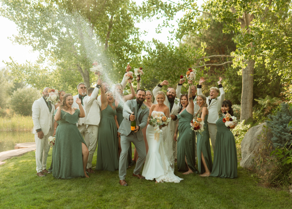 Champagne pop wedding party photo