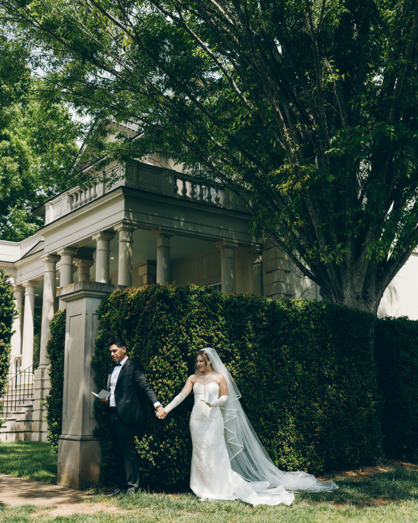 first look with husband and wife before wedding. ivy hedge with estate in the background