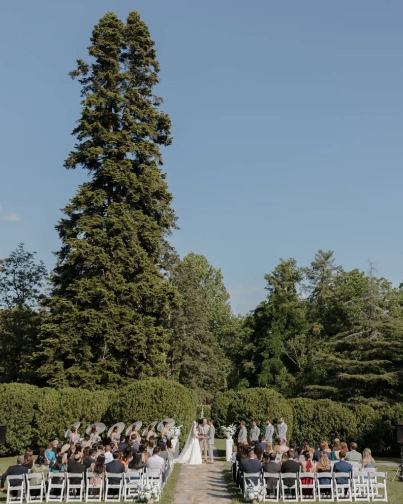 couple at wedding ceremony first kiss ourdoor garden wedding