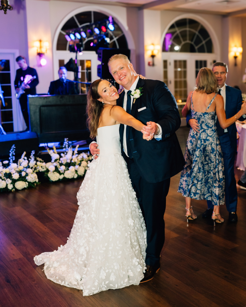 Kelly and Jason smile together on the dance floor during their wedding reception at Riverwalk Event Venue in Rock Hill, South Carolina.