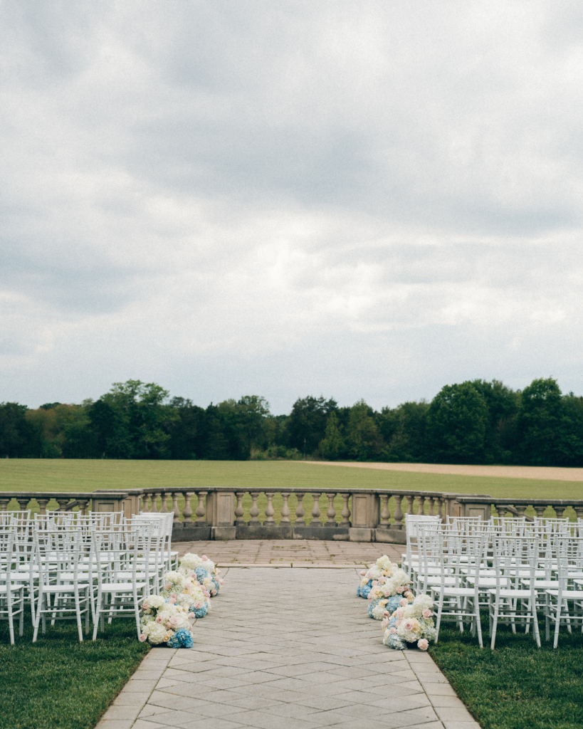 outdoor wedding ceremony looking out on field