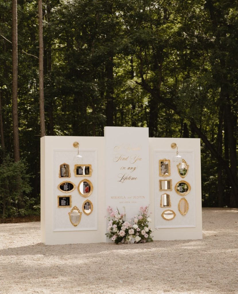 Memorial display table with framed photos and florals