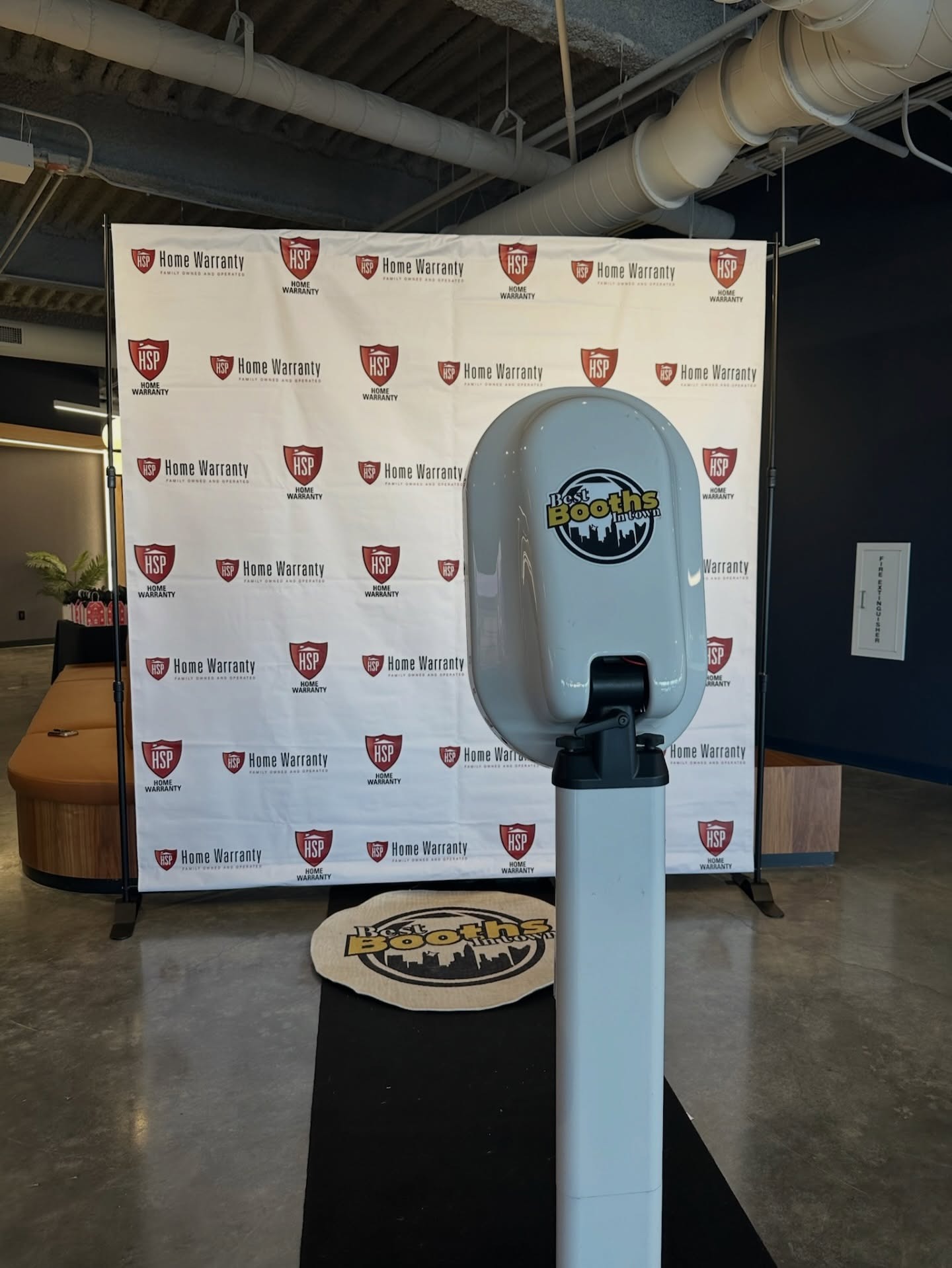 Best Booths in Town photo booth set up in front of a custom branded backdrop at a Columbus event.