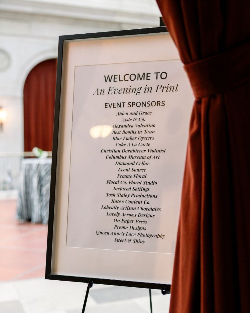 Framed welcome sign listing sponsors for An Evening in Print at the Columbus Museum of Art.