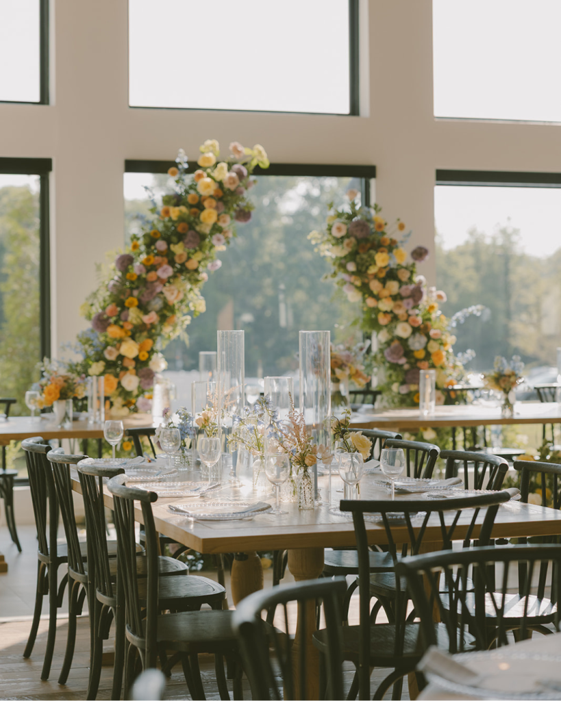 Colorful floral arrangements decorate the ceremony and reception space at White Willow Meadows.