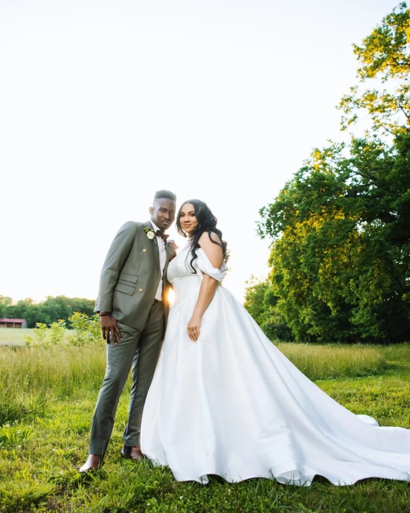 bride and groom posing together during couples portraits in countryside wedding venue near river in leesburg virginia