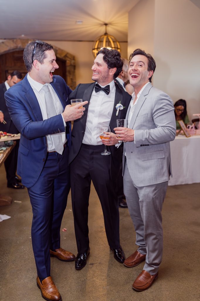 Groom laughing together with guests at wedding reception at winery in northern virginia