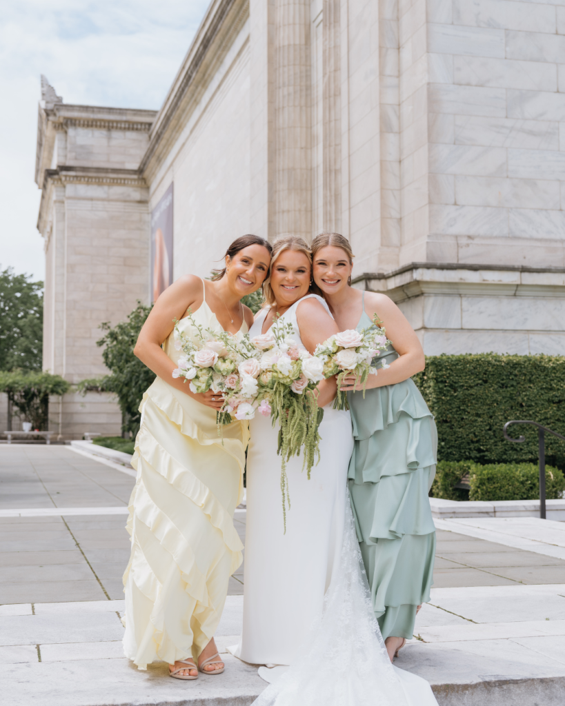 bridesmaids with brides in tiered pastel bridesmaid dresses