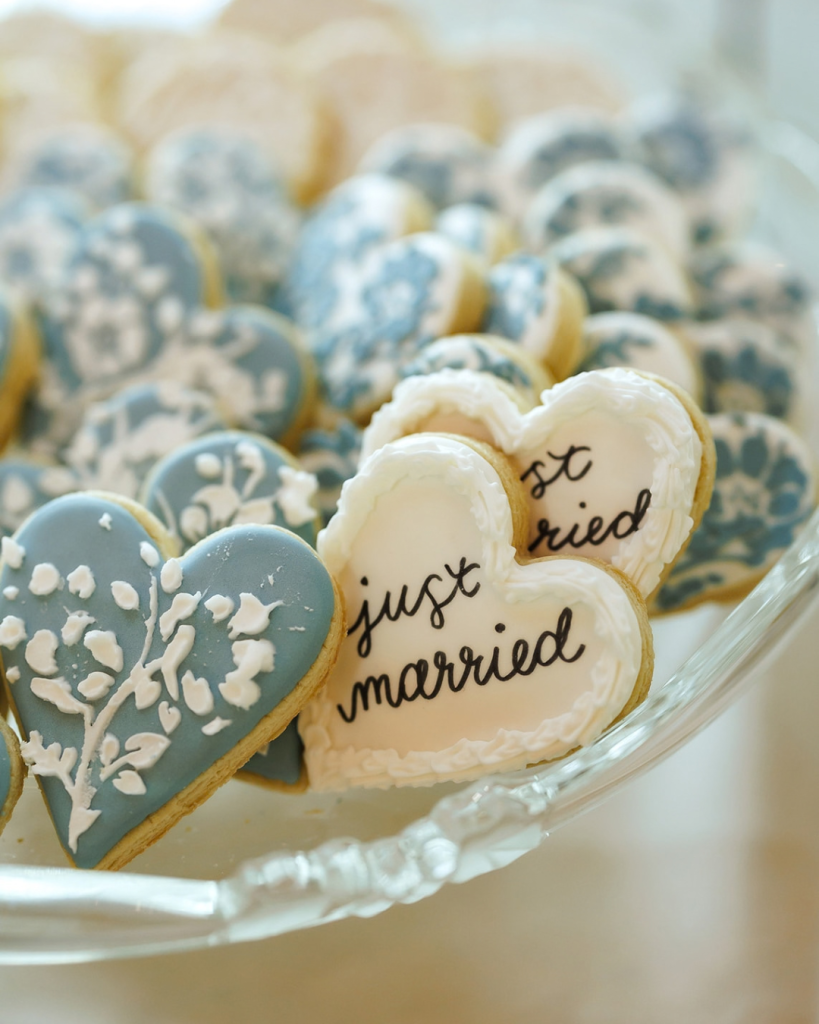 blue and white wedding cookies that say just married