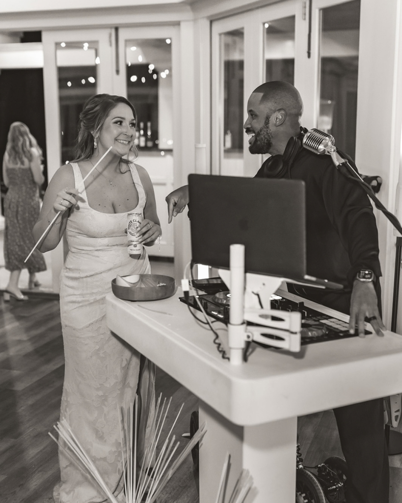 DJ at wedding talking with guest