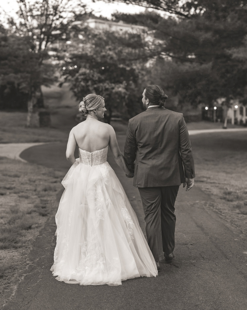 bride and groom strolling through gardens