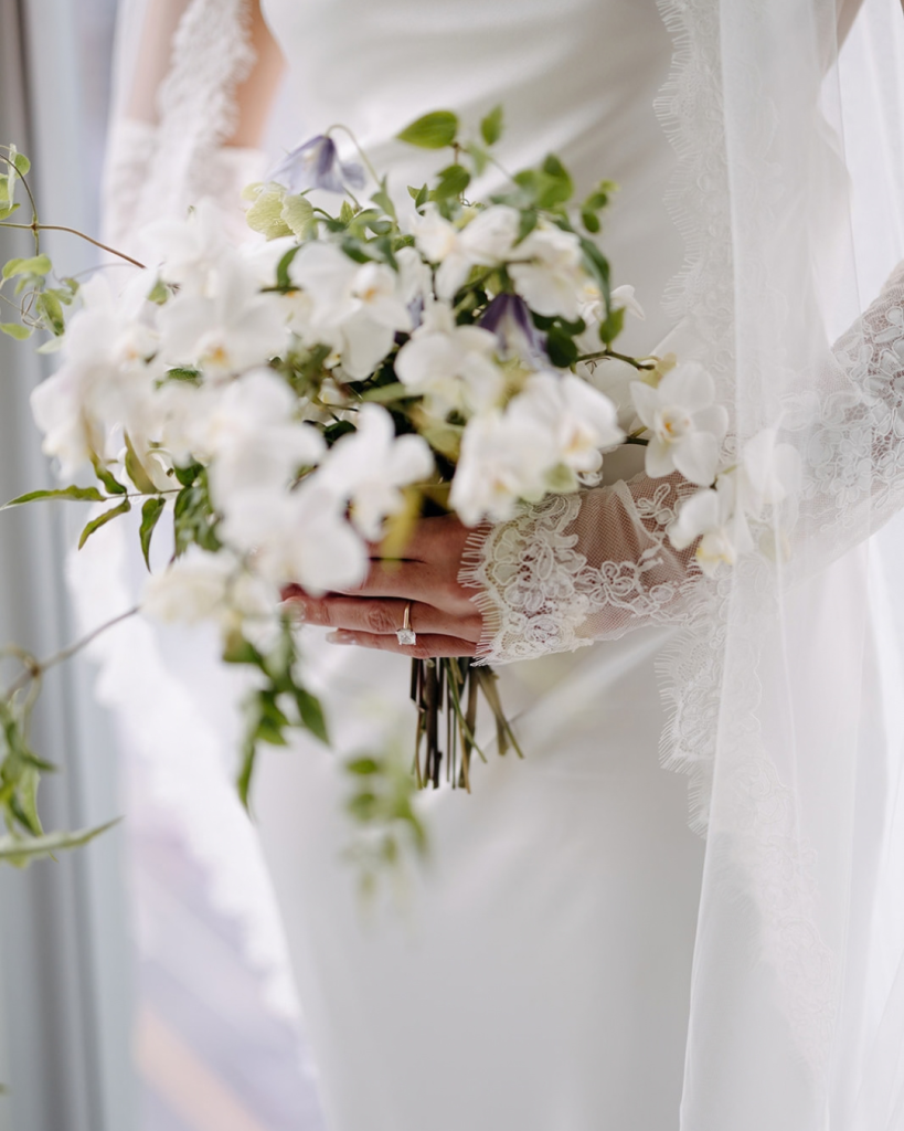 Elegant centerpiece featuring cascading white florals and greenery.