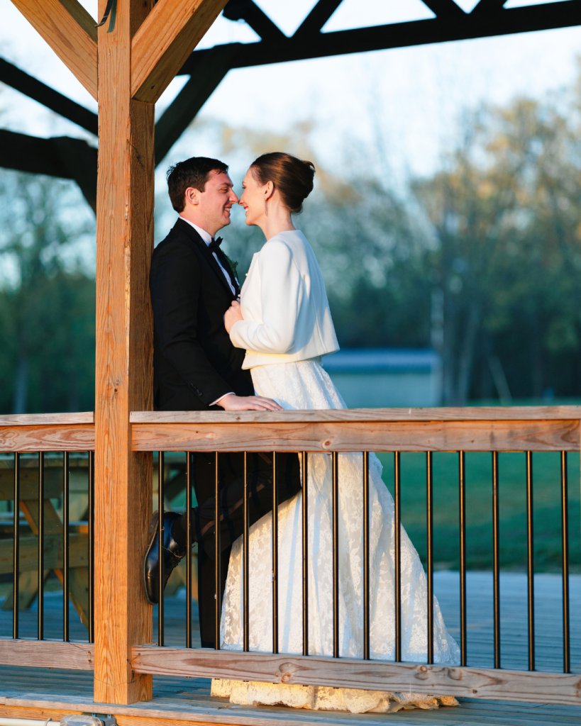 Tate and Alex share a quiet portrait beneath the wooden pavilion at The Union Exchange during golden hour.