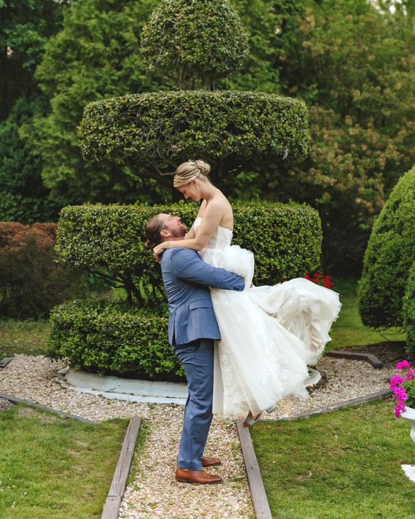 garden wedding groom lifting up bride